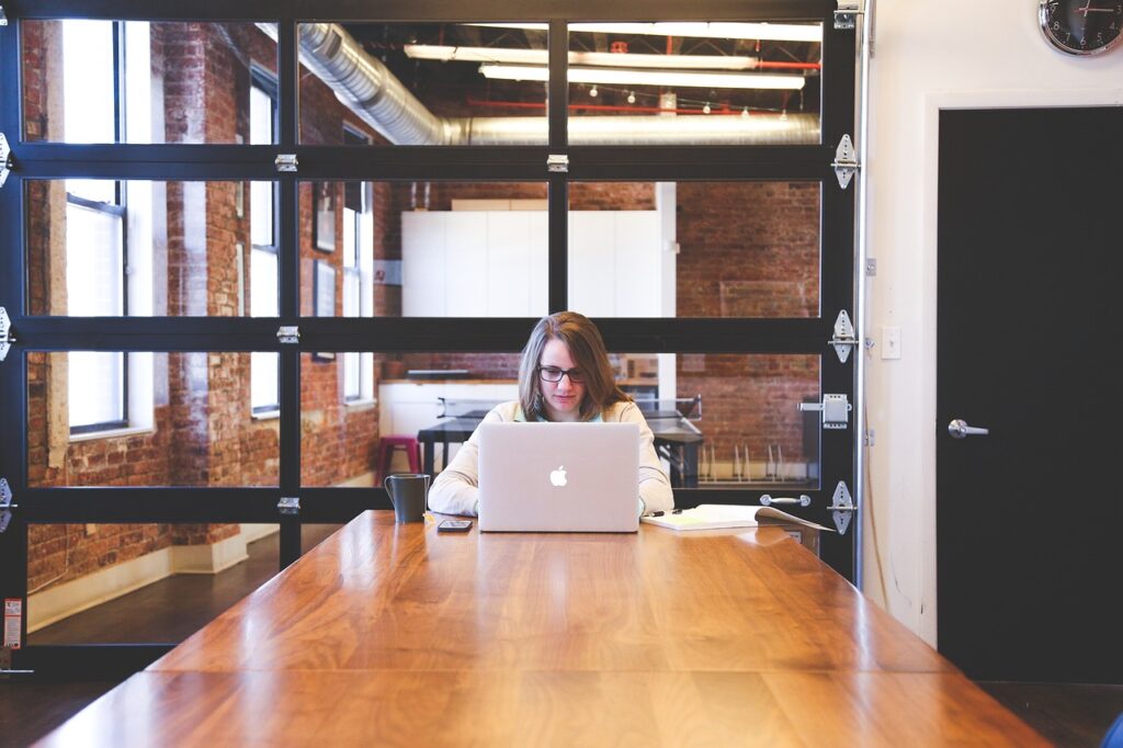 women work on mac in startup office